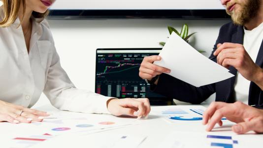 Deals being made at a desk with a man and woman